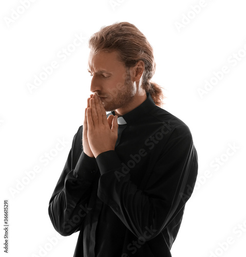 Handsome praying priest on ...