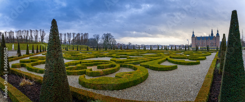 Frederiksborg castle , with ornamental landscape gardened shrubs in the foreground, Hillerod, Denmark photo