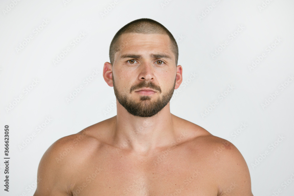 Portrait of a man looking at the camera is brutal, short hairstyle and beard.