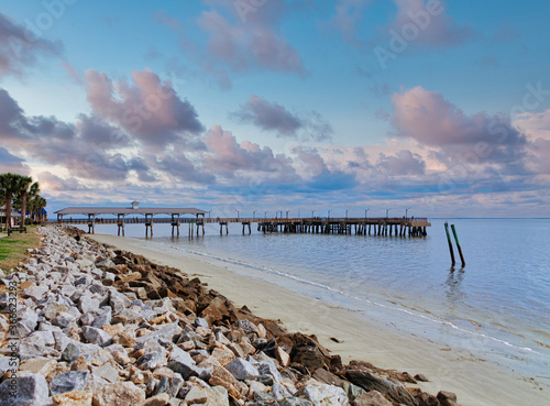 Canvastavla An old fishing pier on St Simons Island beyond rock seawall