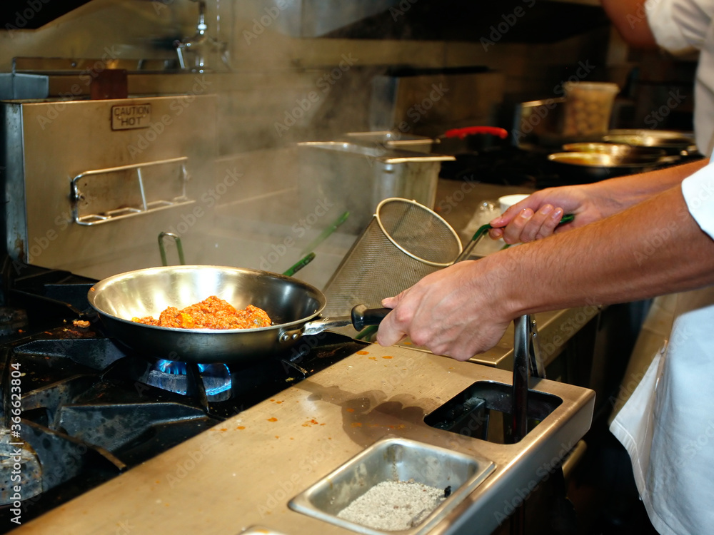 Professional kitchen: chef is making sauce Professional kitchen: chef is making sauce