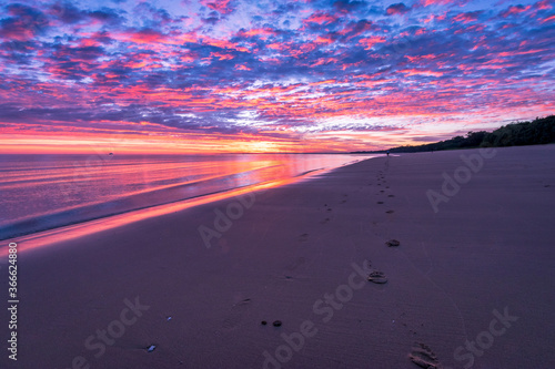 Foot prints along sunrise beach