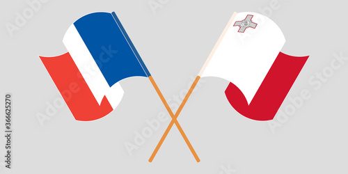 Crossed and waving flags of Malta and France