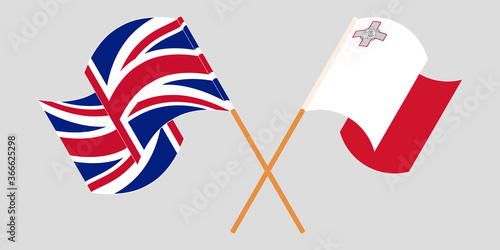 Crossed and waving flags of Malta and the UK