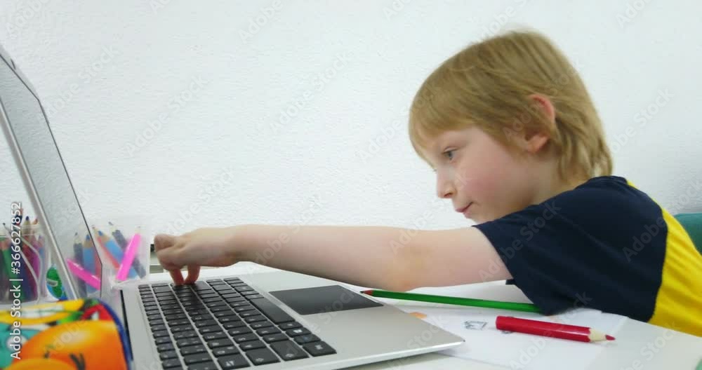 Five years old boy with tablet and drawing tools. Distance online education with digital tablet and notebook doing school homework. Five years old boy with tablet and drawing tools. Distance online education with digital tablet and notebook doing school homework.