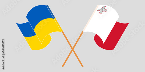 Crossed and waving flags of Malta and Ukraine