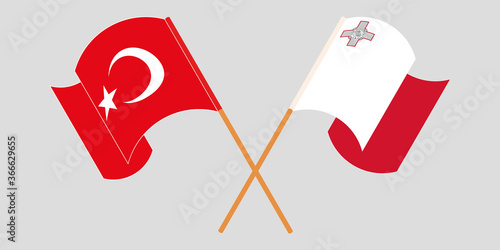 Crossed and waving flags of Malta and Turkey