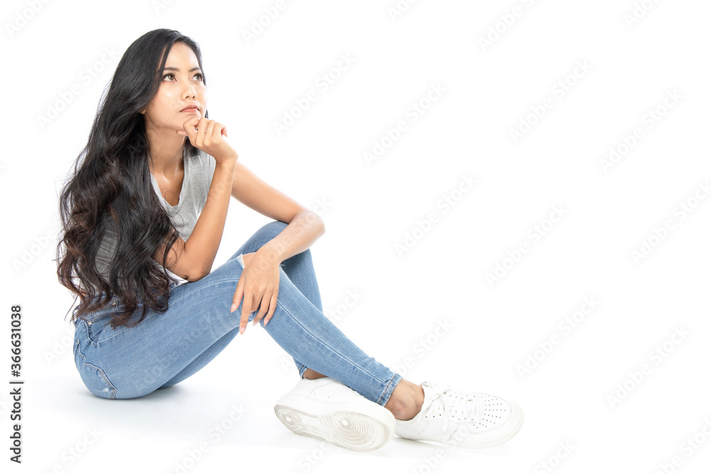 Isolated Asian women sit on the floor daydreams and thinks