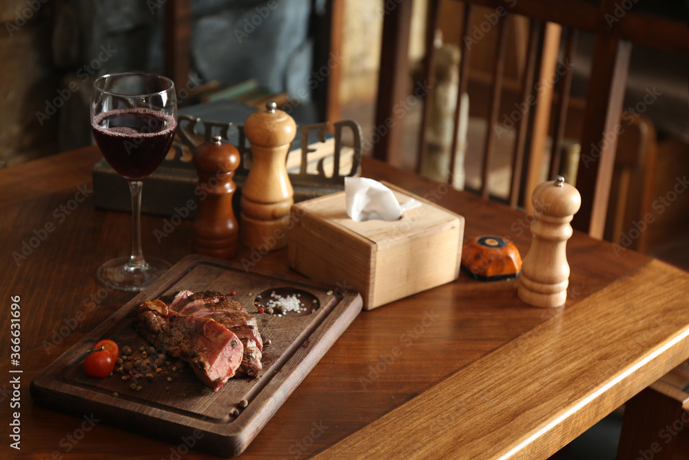 Tasty roasted meat served on wooden table in restaurant. Cooking food Tasty roasted meat served on wooden table in restaurant. Cooking food