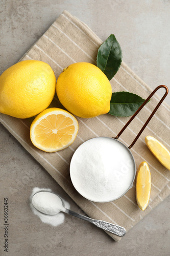 Baking soda and cut lemons on light table, flat lay