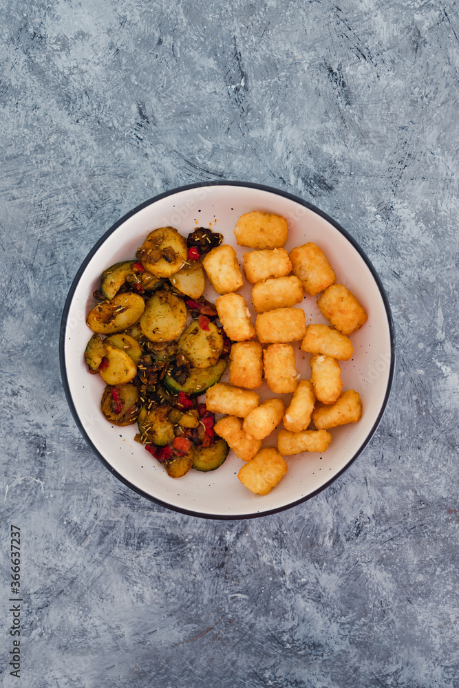 plant-based food, sauteed mediterranean vegetables with soy sauce and wir fried potato royals plant-based food, sauteed mediterranean vegetables with soy sauce and wir fried potato royals