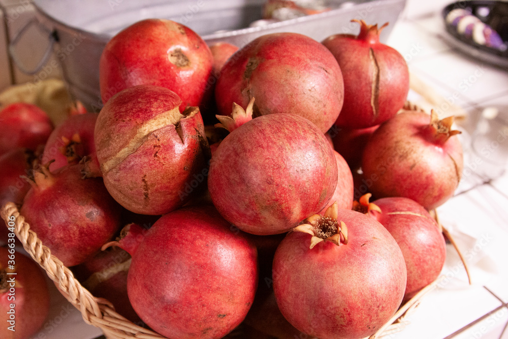 Pile of red pomegranates on kitchen counter Pile of red pomegranates on kitchen counter