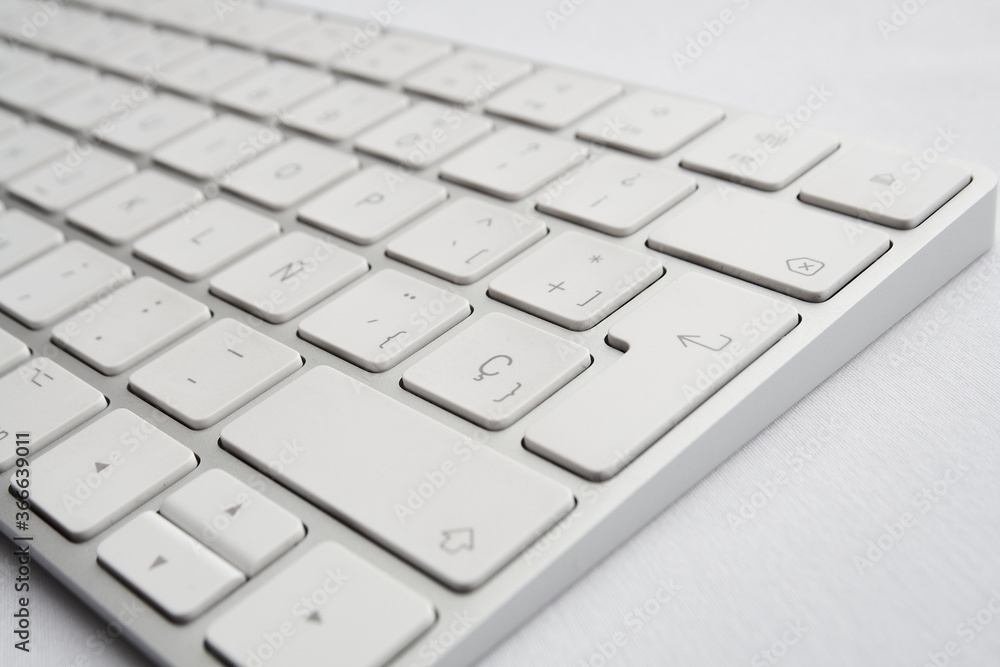 detail elegant and minimalist white wireless keyboard, perspective view detail elegant and minimalist white wireless keyboard, perspective view
