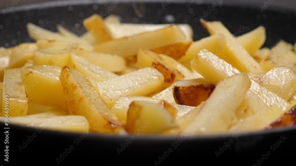 Cooking fried potato on frying pan. Roasting sliced potatoes. Nobody Cooking fried potato on frying pan. Roasting sliced potatoes. Nobody
