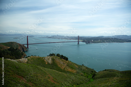 Golden Gate Bridge in San Francisco over the bay with boats moving under bridge
