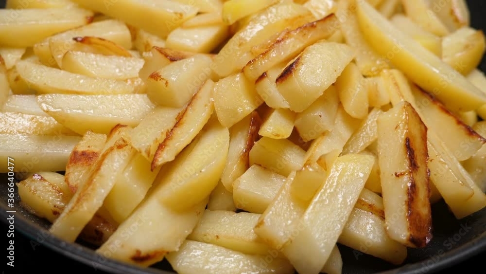 Cooking fried potato on frying pan. Roasting sliced potatoes. Nobody Cooking fried potato on frying pan. Roasting sliced potatoes. Nobody