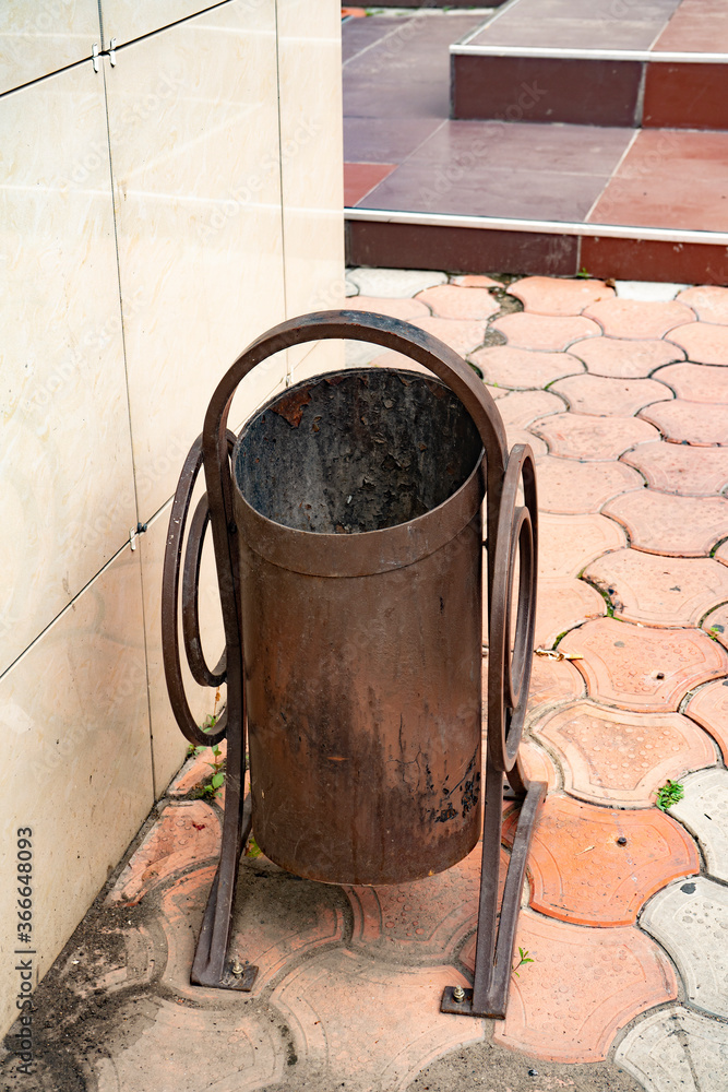 Brown metal rubbish on the pavement. Brown metal rubbish on the pavement.
