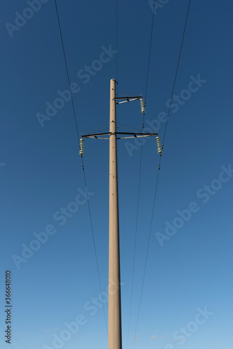 Concrete pole against the blue sky.