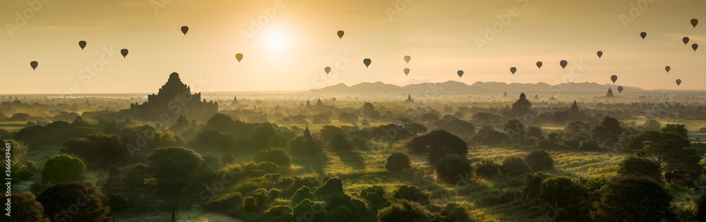 Hot air balloon over plain of Bagan in misty morning, Myanmar at sunrise