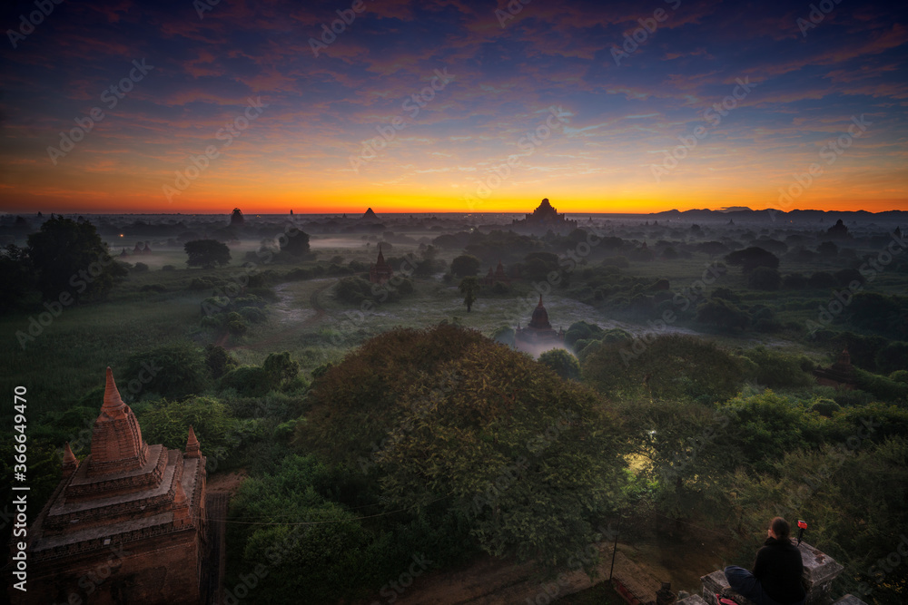 Hot air balloon over plain of Bagan in misty morning, Myanmar at sunrise