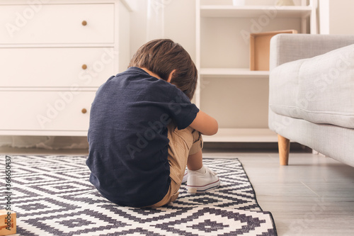 Sad little boy with autisti...