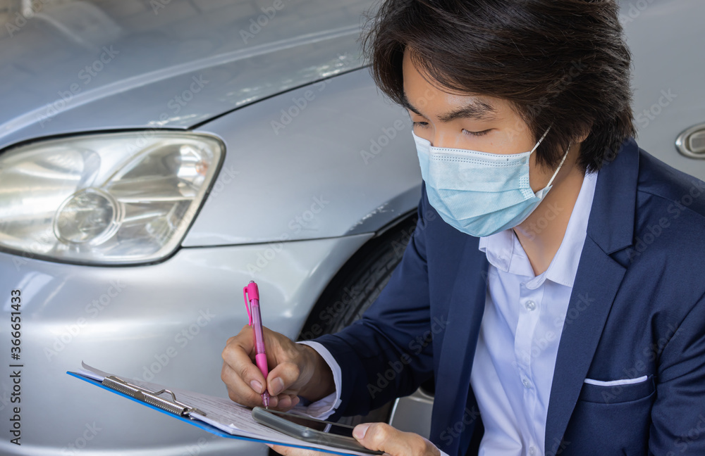 Asian Insurance Agent or Insurance Agency in Suit Wear Mask Writing Car Crash Report and Inspecting Car from Accident for Claim at Outdoor Place in Zoom View Asian Insurance Agent or Insurance Agency in Suit Wear Mask Writing Car Crash Report and Inspecting Car from Accident for Claim at Outdoor Place in Zoom View