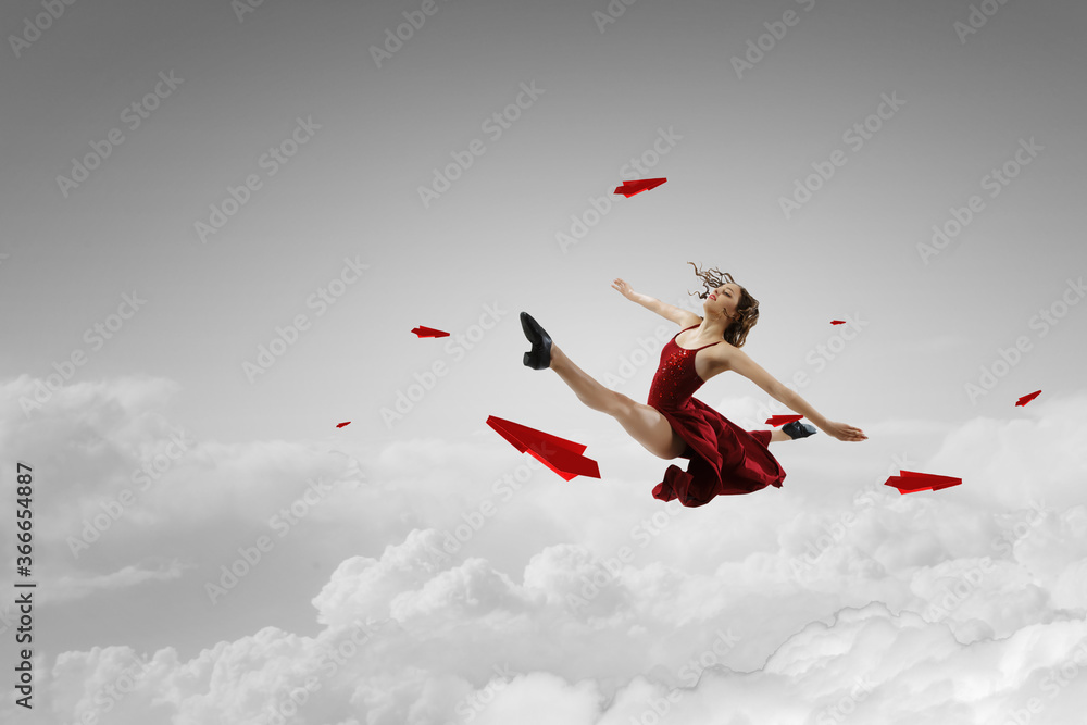 Female dancer against sky background