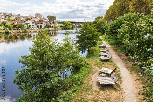 Chaise lounges on a pathway along the Vienne River in Limoges. photo