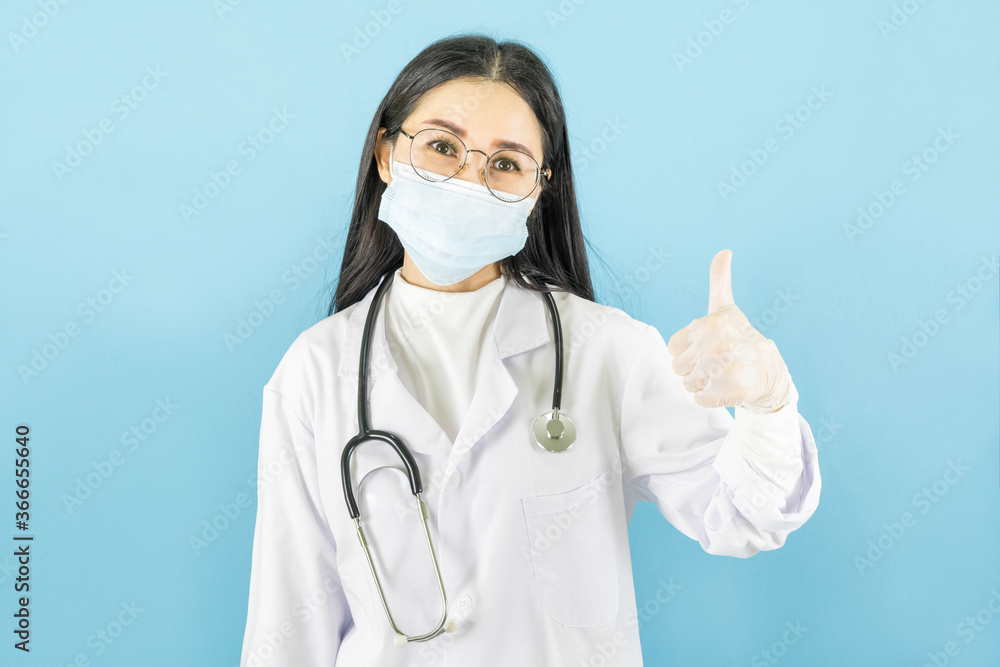 Smart young asian female doctor in lab coat with Medical face mask,white latex medical gloves and stethoscope against blue background,health care concept Smart young asian female doctor in lab coat with Medical face mask,white latex medical gloves and stethoscope against blue background,health care concept