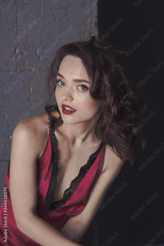Hot young gir stands in red sleep dress in black room. soft focuse Hot young gir stands in red sleep dress in black room. soft focuse