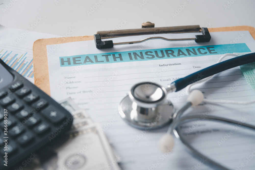 Stethoscope and calculator placed on health insurance documents, Individual medical health insurance. Concept life planning Stethoscope and calculator placed on health insurance documents, Individual medical health insurance. Concept life planning