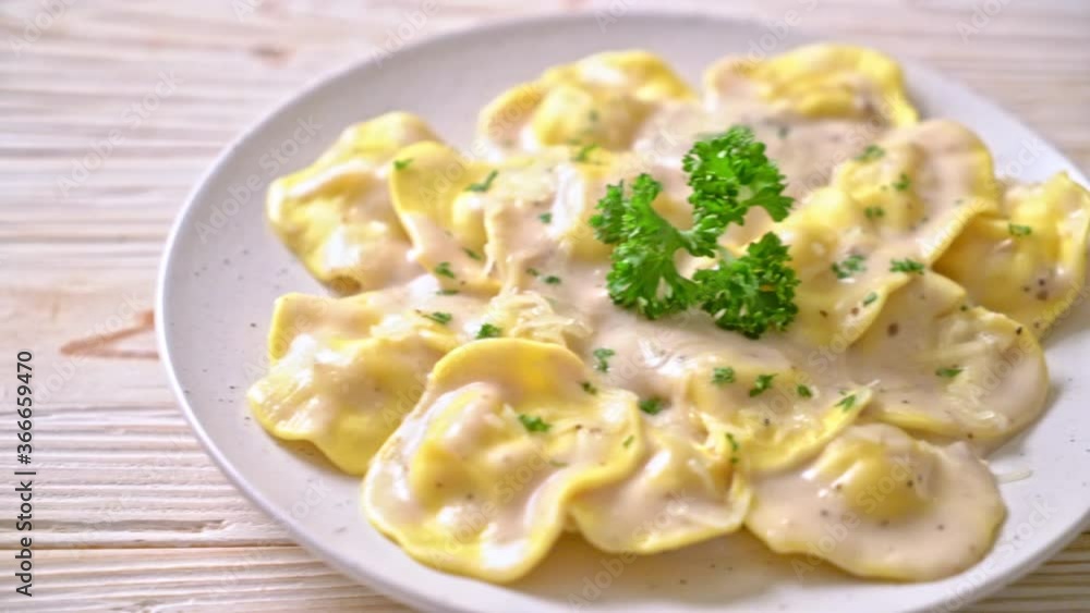 ravioli pasta with mushroom cream sauce and cheese - Italian food style ravioli pasta with mushroom cream sauce and cheese - Italian food style