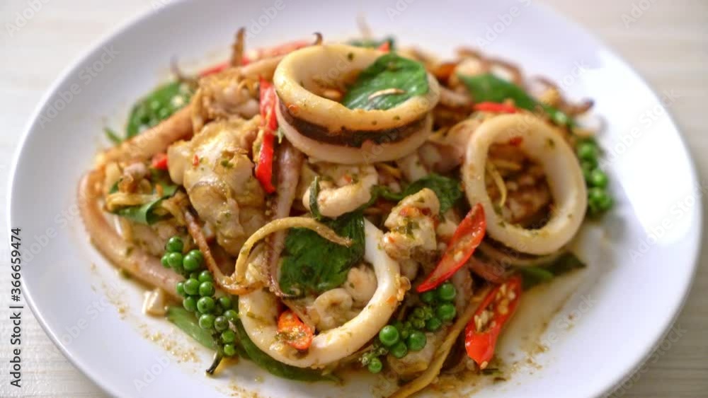 stir fried holy basil with octopus or squid and herb - Asian food style stir fried holy basil with octopus or squid and herb - Asian food style
