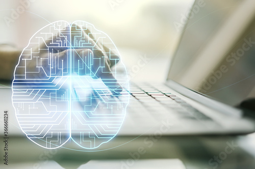 Double exposure of creative artificial Intelligence symbol with hands typing on laptop on background. Neural networks and machine learning concept photo