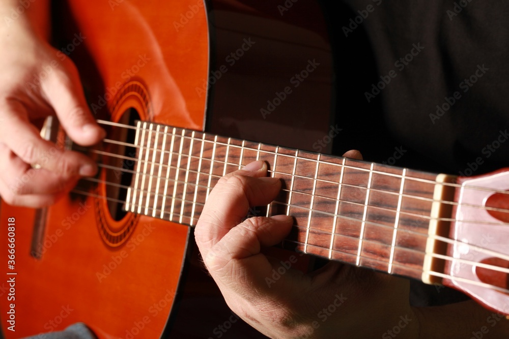 Fototapeta premium Man playing an acoustic guitar