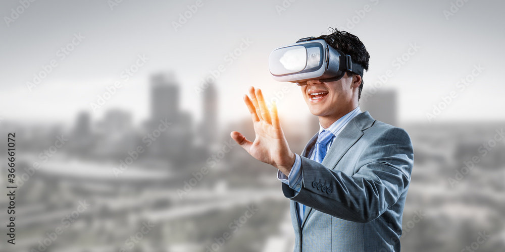 Businessman in VR glasses . Mixed media Businessman in VR glasses . Mixed media