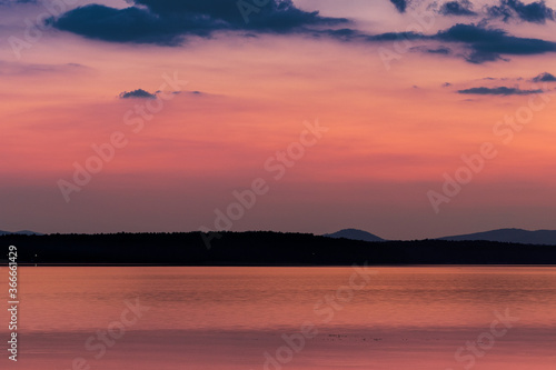 View of the opposite shore of the lake at dusk. © Mikhail Galyshev
