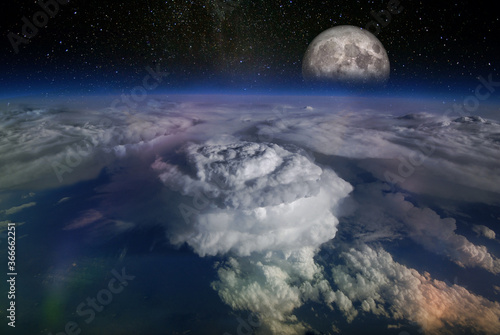 Landscape from space  with huge hurricane birth clouds and starry sky and moonrise. Elements of this image furnished by NASA.