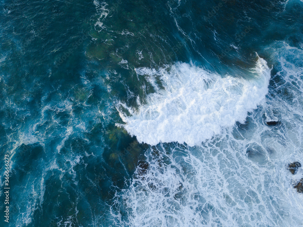 Aerial view of wave breaking on the beach.