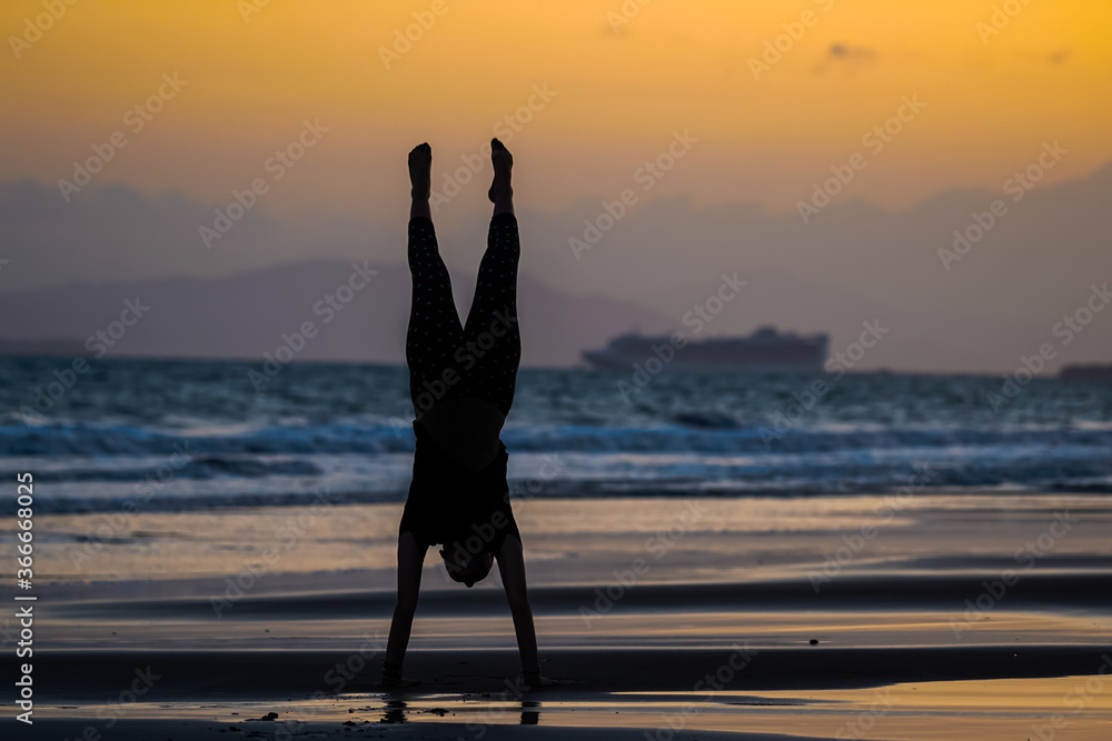 Fototapeta premium Beautiful silhouette image of Kids playing and enjoying at the Beach in Costa Rica