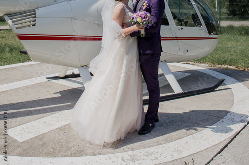 the groom with bride near the helicopter