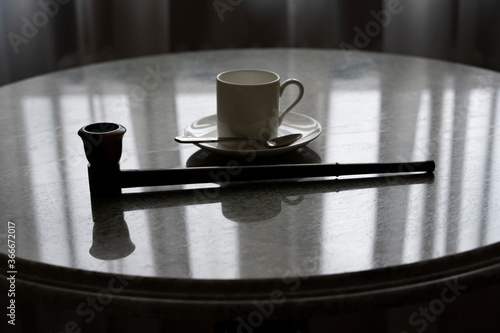 cup of morning coffee on a round marble table with different items