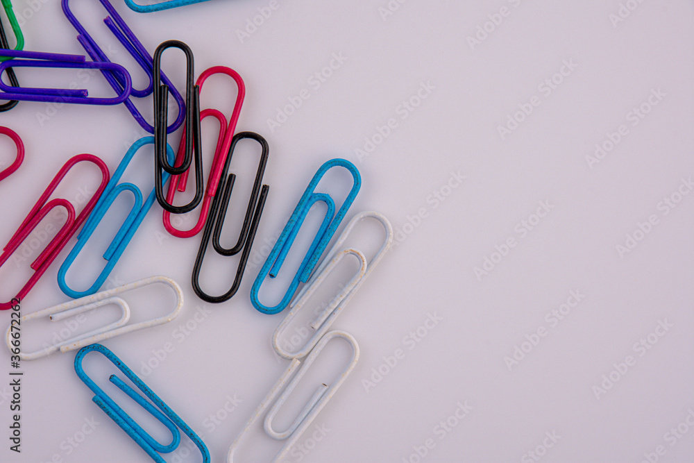 Colored paper clips on white background Colored paper clips on white background