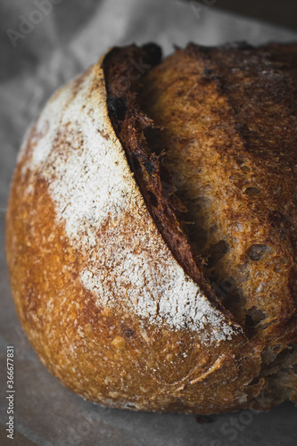 loaf of bread with sesame seeds on wooden background