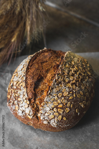 loaf of bread with sesame seeds on wooden background