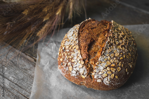 loaf of bread with sesame seeds on wooden background