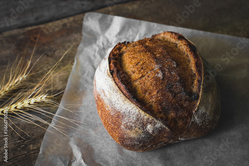 loaf of bread with sesame seeds on wooden background