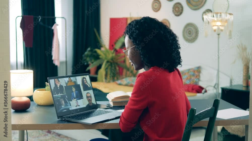 Online learning, distance eductaion, remote studying concept. Self-isolating african lady is participating in a video conference Online learning, distance eductaion, remote studying concept. Self-isolating african lady is participating in a video conference