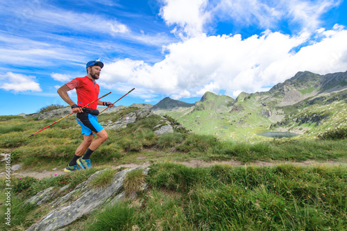Trail running with poles in the mountains