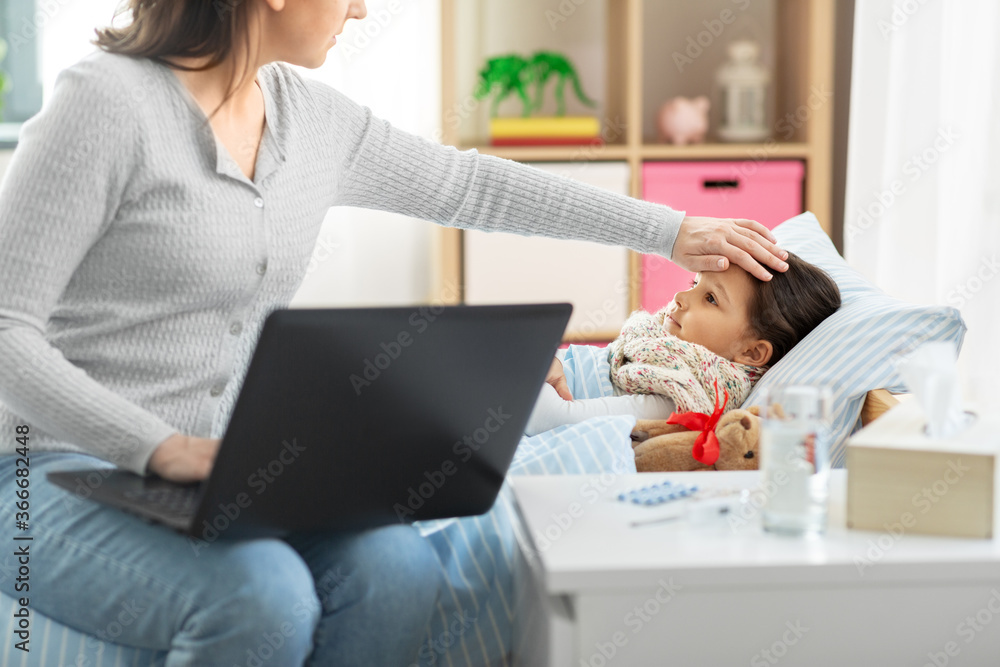 family, health and people concept - ill daughter and mother with laptop computer at home family, health and people concept - ill daughter and mother with laptop computer at home